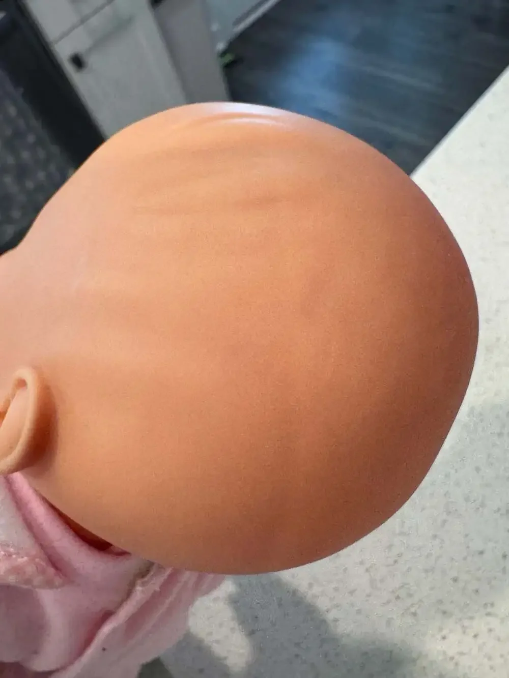 Soft Body Baby Doll with Vinyl Head and Pink Animal Applique Bib
